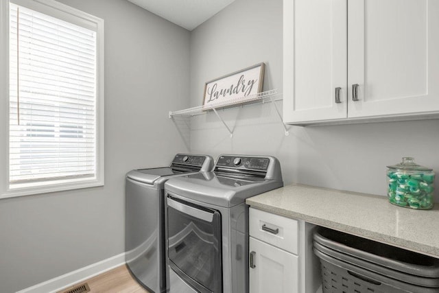 5201 Ramier Ave NE, Otsego, MN 55374 - laundry room featuring washing machine and dryer, cabinet space, and baseboards