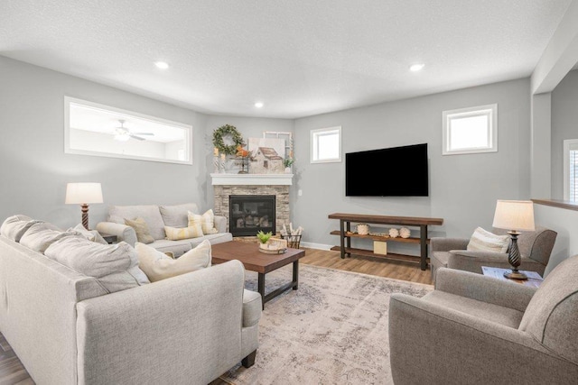 5201 Ramier Ave NE, Otsego, MN 55374 - living area featuring wood finished floors, recessed lighting, healthy amount of natural light, and a fireplace