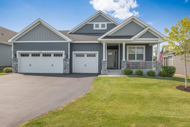 5201 Ramier Ave NE, Otsego, MN 55374 - craftsman-style home featuring board and batten siding, driveway, an attached garage, and covered porch