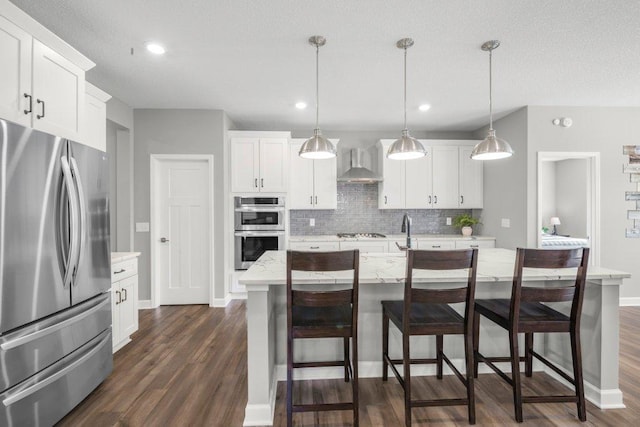 5201 Ramier Ave NE, Otsego, MN 55374 - kitchen with stainless steel appliances, wall chimney exhaust hood, dark wood finished floors, backsplash, and a breakfast bar area