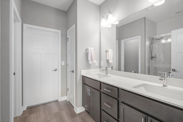 5201 Ramier Ave NE, Otsego, MN 55374 - bathroom featuring a shower stall, double vanity, and baseboards