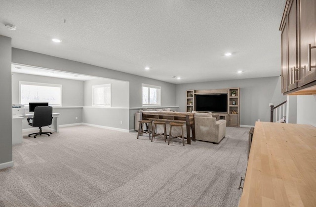 5201 Ramier Ave NE, Otsego, MN 55374 - living room featuring an office area, a textured ceiling, light colored carpet, recessed lighting, and baseboards