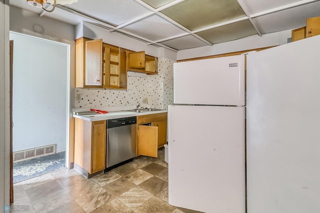 1002 10th St N, Fargo, ND 58102 - kitchen with dishwasher, freestanding refrigerator, light countertops, and tasteful backsplash