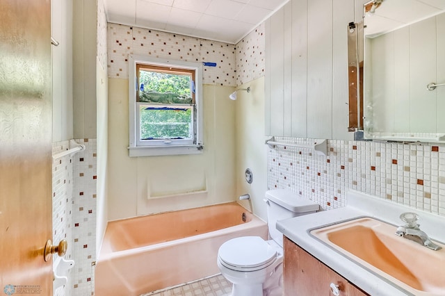 1002 10th St N, Fargo, ND 58102 - bathroom with vanity, tub / shower combination, tile walls, and backsplash
