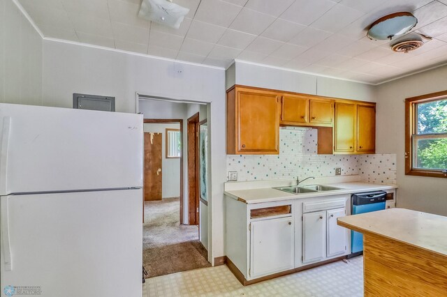 1002 10th St N, Fargo, ND 58102 - kitchen with freestanding refrigerator, light countertops, dishwasher, decorative backsplash, and light floors
