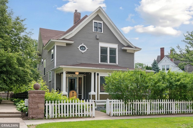 76 Western Ave N, Saint Paul, MN 55102 - view of front of home featuring covered porch, a chimney, and a fenced front yard