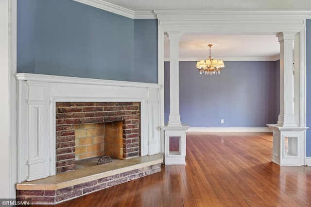 76 Western Ave N, Saint Paul, MN 55102 - unfurnished living room with hardwood / wood-style floors, a chandelier, a fireplace with raised hearth, decorative columns, and ornamental molding