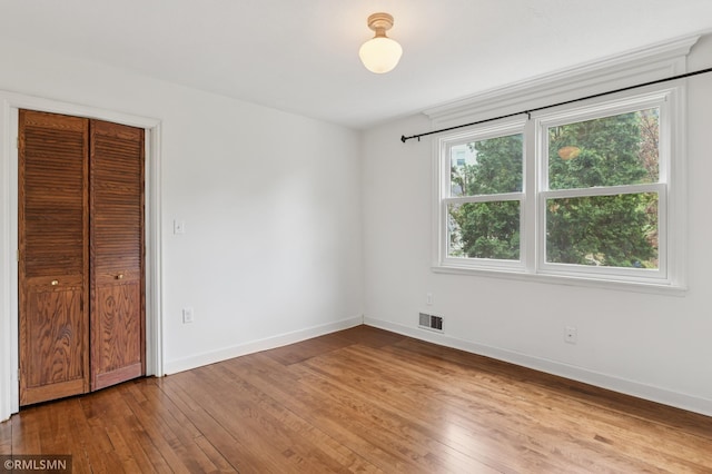 76 Western Ave N, Saint Paul, MN 55102 - unfurnished bedroom featuring hardwood / wood-style flooring and a closet