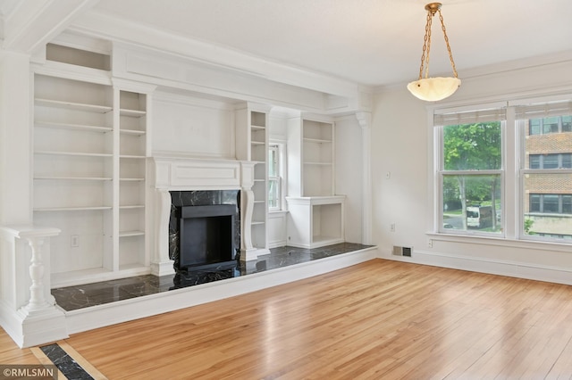 76 Western Ave N, Saint Paul, MN 55102 - unfurnished living room with wood finished floors, a premium fireplace, built in features, and crown molding
