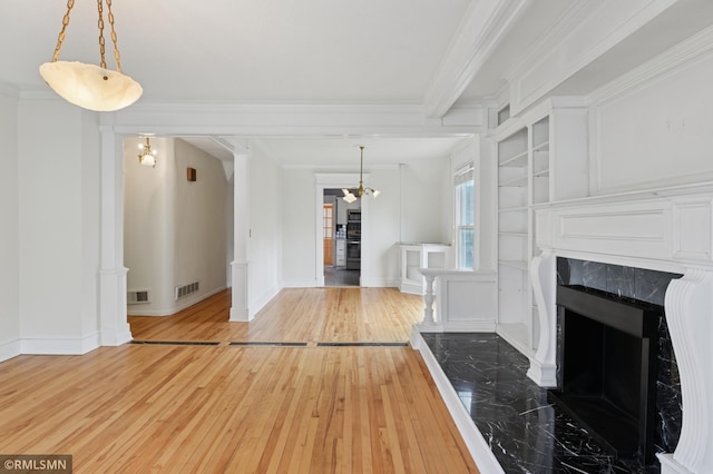 76 Western Ave N, Saint Paul, MN 55102 - unfurnished living room featuring wood-type flooring, a high end fireplace, ornamental molding, and a chandelier