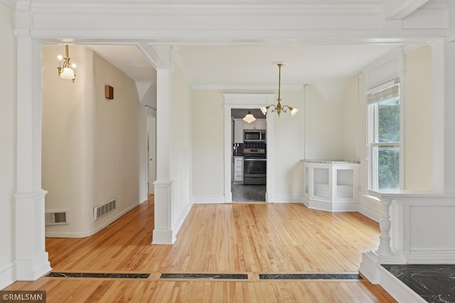 76 Western Ave N, Saint Paul, MN 55102 - unfurnished dining area featuring light wood-style floors, a chandelier, and ornamental molding