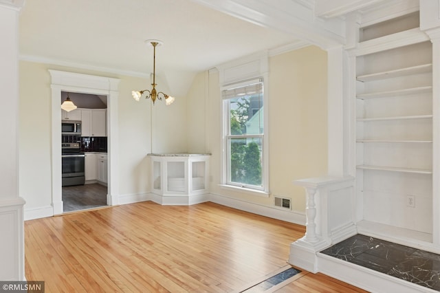 76 Western Ave N, Saint Paul, MN 55102 - unfurnished dining area featuring light wood-type flooring, a chandelier, ornamental molding, and built in features