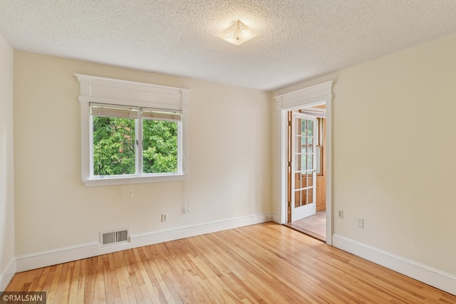 76 Western Ave N, Saint Paul, MN 55102 - spare room featuring wood-type flooring and a textured ceiling