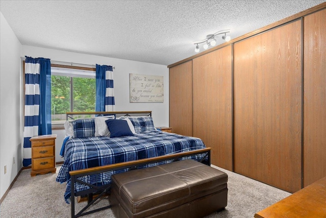 7079 Robinwood Trl, Woodbury, MN 55125 - carpeted bedroom with a textured ceiling and a closet