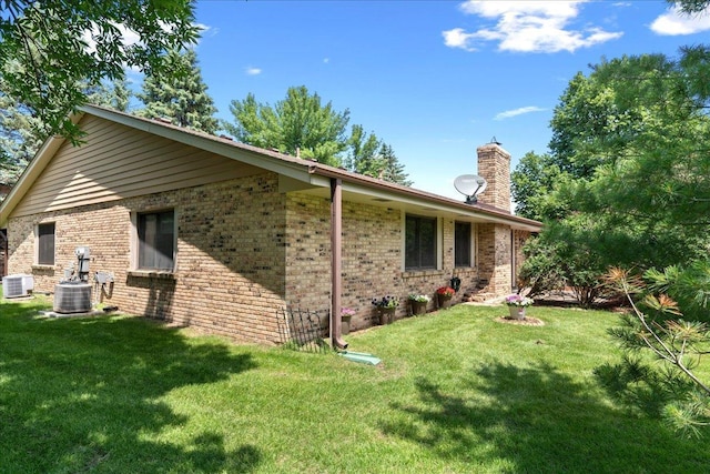 7079 Robinwood Trl, Woodbury, MN 55125 - view of home's exterior featuring a chimney, a yard, and brick siding