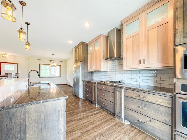 39847 447th St, Sauk Centre Twp, MN 56378 - kitchen with appliances with stainless steel finishes, wall chimney range hood, a sink, light wood-type flooring, and a chandelier