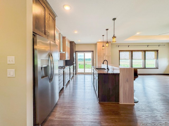 39847 447th St, Sauk Centre Twp, MN 56378 - kitchen with stainless steel refrigerator with ice dispenser, dark wood-type flooring, a sink, a kitchen island with sink, and dark stone counters