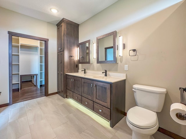 39847 447th St, Sauk Centre Twp, MN 56378 - bathroom with double vanity, toilet, and baseboards