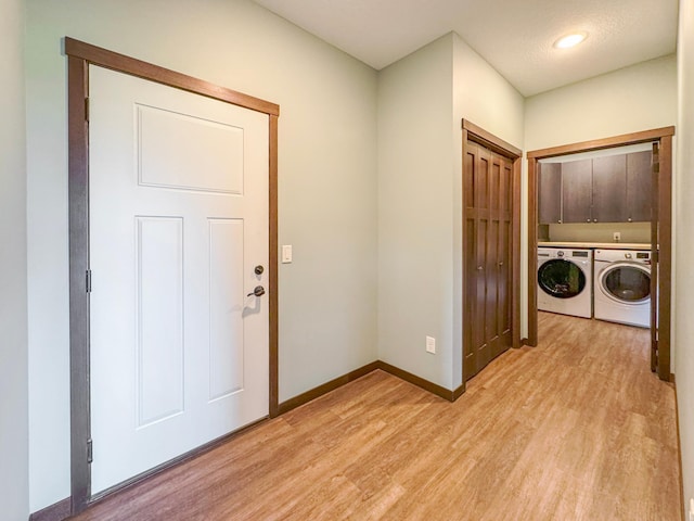 39847 447th St, Sauk Centre Twp, MN 56378 - laundry area with cabinet space, washer and dryer, light wood-type flooring, and baseboards