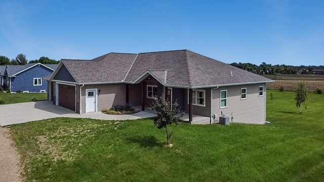 39847 447th St, Sauk Centre Twp, MN 56378 - view of front of property featuring driveway, a front lawn, an attached garage, cooling unit, and a shingled roof
