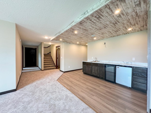 39847 447th St, Sauk Centre Twp, MN 56378 - indoor wet bar with fridge, stairs, beverage cooler, light wood-style floors, and baseboards