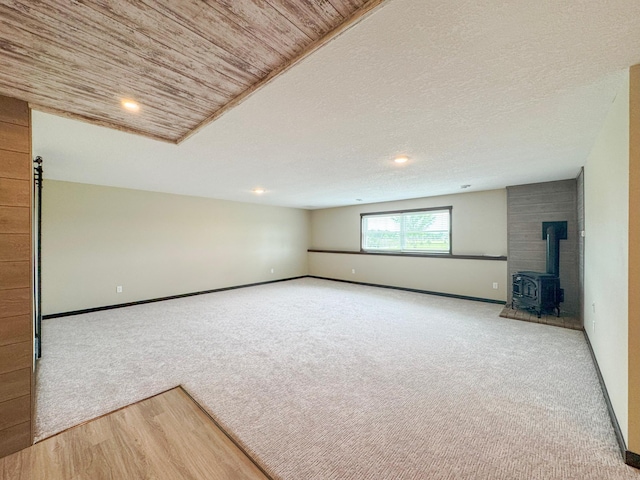 39847 447th St, Sauk Centre Twp, MN 56378 - carpeted spare room with a wood stove, baseboards, and recessed lighting