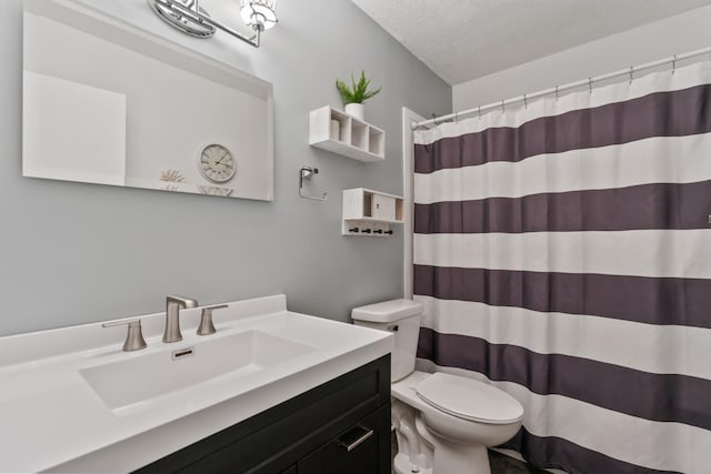 2452 Parkview Ln SE, Rochester, MN 55904 - bathroom with toilet, vanity, a textured ceiling, and curtained shower