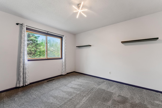2452 Parkview Ln SE, Rochester, MN 55904 - spare room featuring carpet flooring, a textured ceiling, and baseboards
