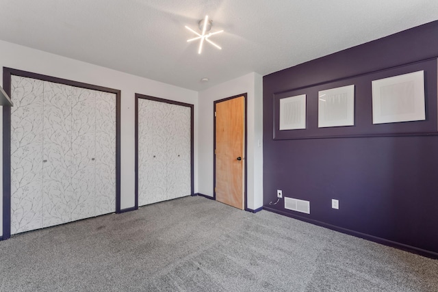 2452 Parkview Ln SE, Rochester, MN 55904 - unfurnished bedroom with carpet, two closets, and baseboards