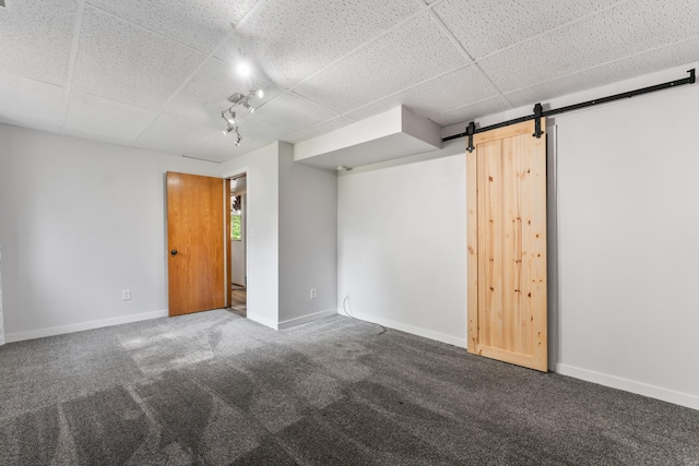 2452 Parkview Ln SE, Rochester, MN 55904 - unfurnished room with a drop ceiling, carpet floors, a barn door, and baseboards