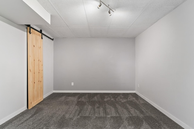 2452 Parkview Ln SE, Rochester, MN 55904 - finished below grade area with dark carpet, a barn door, a drop ceiling, rail lighting, and baseboards
