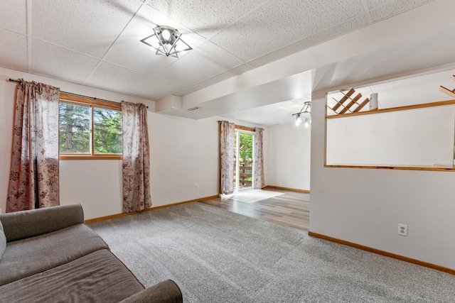 2452 Parkview Ln SE, Rochester, MN 55904 - living room with carpet flooring, baseboards, healthy amount of natural light, and a paneled ceiling