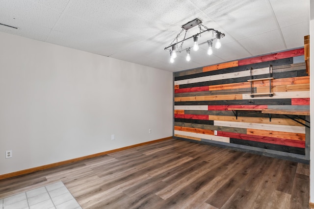 2452 Parkview Ln SE, Rochester, MN 55904 - empty room featuring wood walls, wood finished floors, and baseboards