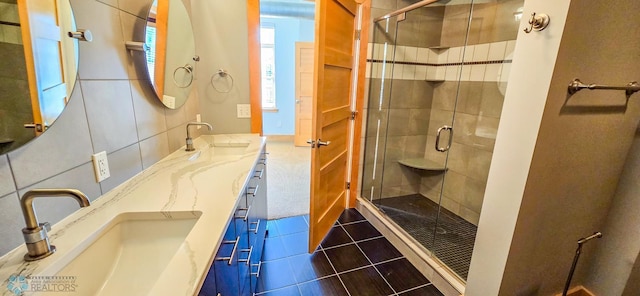 319 Broadway N Unit 306, Fargo, ND 58102 - bathroom featuring a shower stall, double vanity, and tile patterned flooring