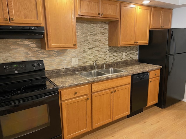 411 Broadway St, Redwood Falls, MN 56283 - kitchen with black appliances, ventilation hood, light wood-style floors, and decorative backsplash
