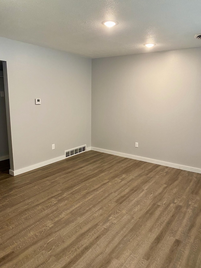 411 Broadway St, Redwood Falls, MN 56283 - unfurnished room with dark wood-type flooring and a textured ceiling