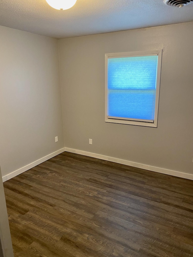411 Broadway St, Redwood Falls, MN 56283 - unfurnished room featuring dark wood finished floors and baseboards