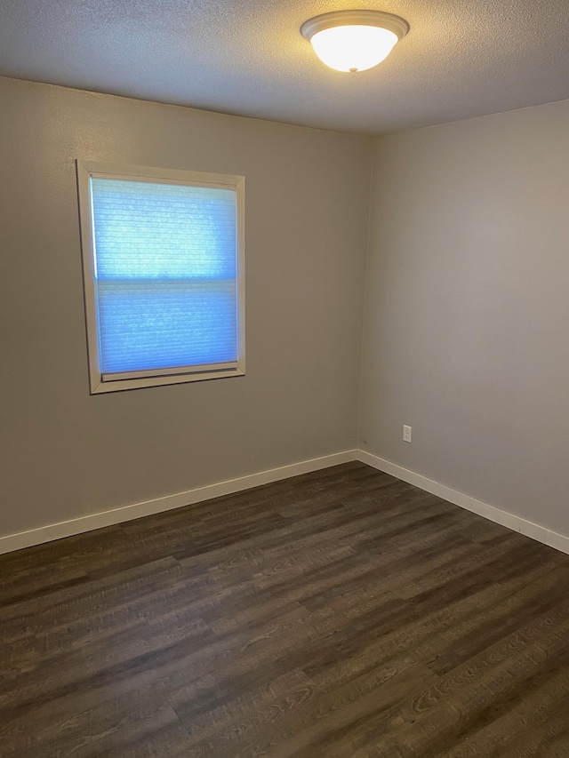 411 Broadway St, Redwood Falls, MN 56283 - spare room featuring dark wood-type flooring and baseboards