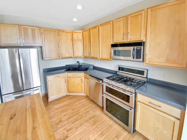 15579 June Grass Ln, Eden Prairie, MN 55347 - kitchen featuring appliances with stainless steel finishes, light brown cabinetry, dark countertops, and recessed lighting