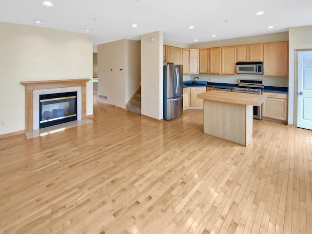 15579 June Grass Ln, Eden Prairie, MN 55347 - kitchen with appliances with stainless steel finishes, light brown cabinets, open floor plan, light wood-style flooring, and recessed lighting