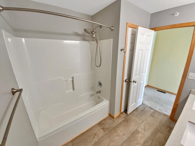 15579 June Grass Ln, Eden Prairie, MN 55347 - bathroom with bathtub / shower combination and a textured ceiling