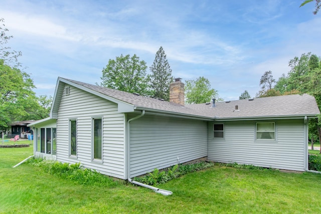 2103 Graydon Ave, Brainerd, MN 56401 - view of side of home with a chimney, a lawn, and a shingled roof