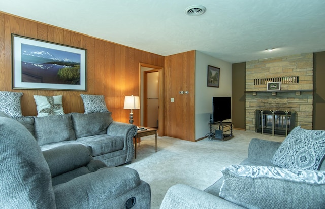 2103 Graydon Ave, Brainerd, MN 56401 - living room featuring carpet, a stone fireplace, and wooden walls