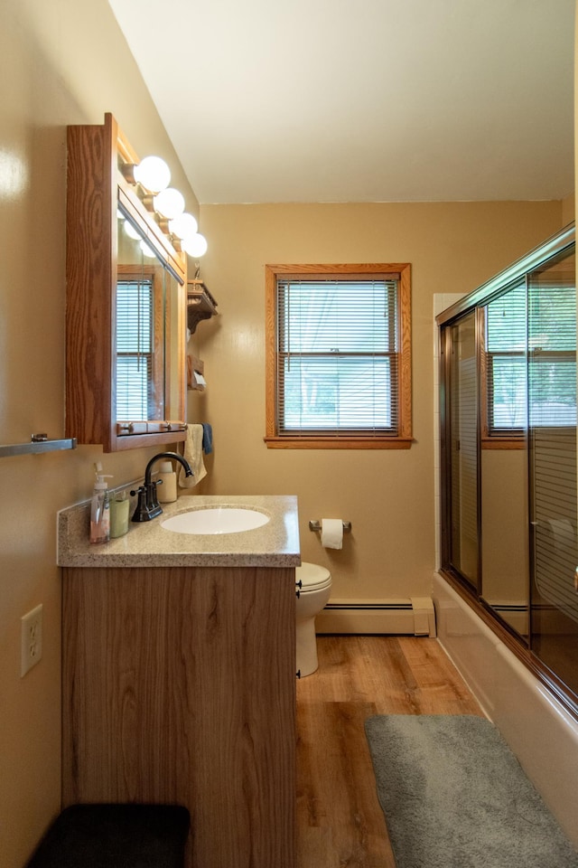 2103 Graydon Ave, Brainerd, MN 56401 - full bathroom featuring a baseboard radiator, healthy amount of natural light, vanity, and wood finished floors