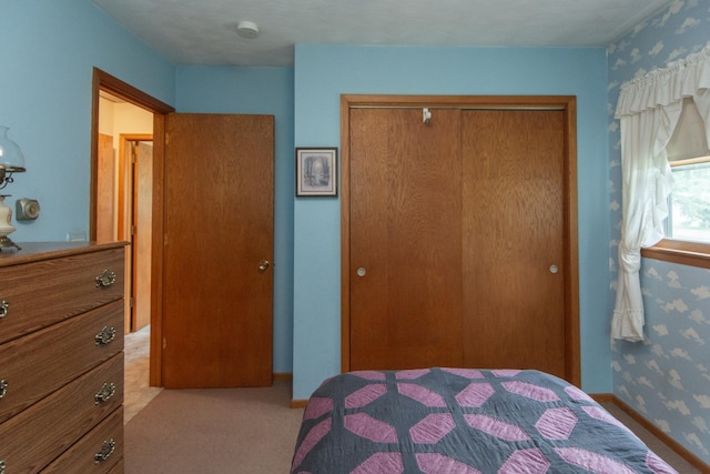2103 Graydon Ave, Brainerd, MN 56401 - bedroom featuring a closet, carpet flooring, and wallpapered walls