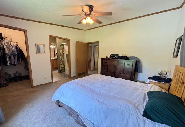 38634 241st St, Aitkin, MN 56431 - carpeted bedroom featuring a walk in closet, ornamental molding, a closet, connected bathroom, and ceiling fan