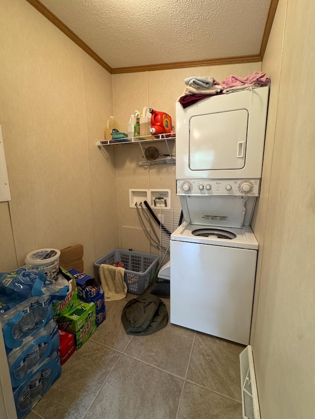 38634 241st St, Aitkin, MN 56431 - laundry room featuring stacked washing machine and dryer, crown molding, tile patterned flooring, a textured ceiling, and a decorative wall
