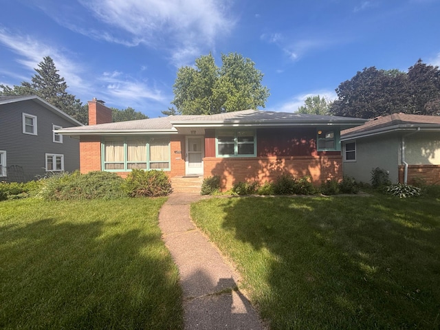 1290 Danforth St, Saint Paul, MN 55117 - view of front of property with brick siding, a front yard, and a chimney