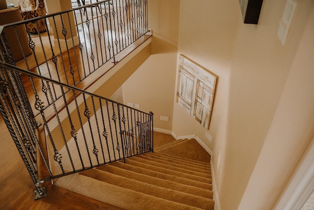 1509 Haller Ct S, Maplewood, MN 55119 - staircase featuring baseboards and a towering ceiling