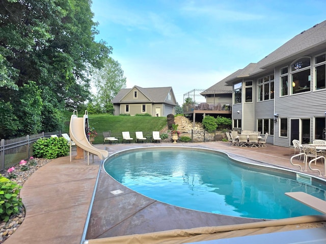 1509 Haller Ct S, Maplewood, MN 55119 - view of swimming pool with a water slide, a patio, a diving board, and outdoor dining area